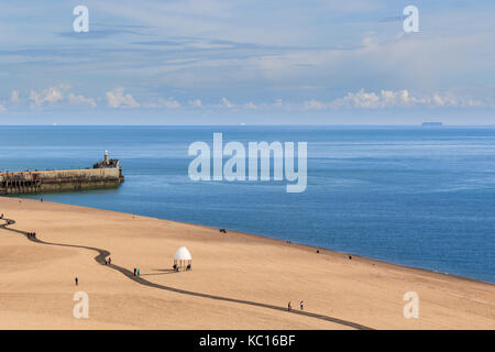 View of Folkestone harbour pier and the Lower Leas, taken from The Leas cliff top. Shipping can be see in the distance. Kent UK Stock Photo