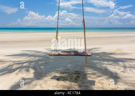 Wooden swing hanging on the beach on Koh Kood island in Thailand. Stock Photo