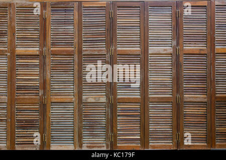 Bunch of wooden window shutters pattern background. Restaurant cafe warehouse decor. Stock Photo