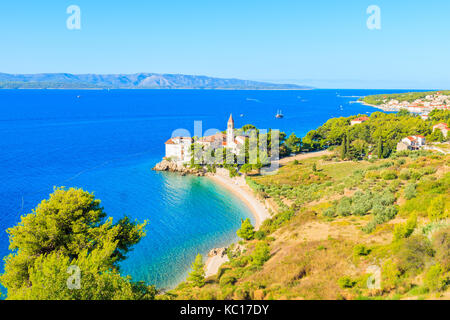 View of beautiful bay with beach and Dominican monastery in Bol town, Brac island, Croatia Stock Photo