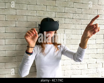Woman looking through virtual reality device Stock Photo