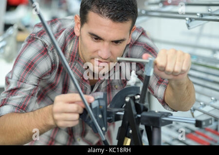 confident man using paper press machine in factory Stock Photo