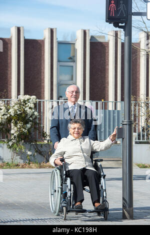 old couple walks on the pedestrian crossing Stock Photo