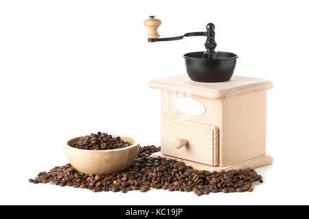 Coffee beans in wooden bowl with wooden coffee bean grinder over white background Stock Photo