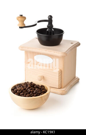 Coffee beans in wooden bowl with wooden coffee bean grinder over white background Stock Photo