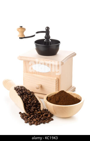 Coffee beans in wooden scoop and ground coffee in wooden bowl with coffee bean grinder over white background Stock Photo