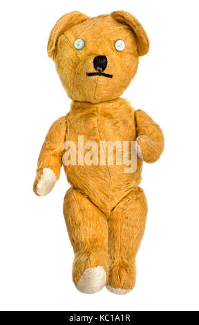 Old, much loved, much repaired, unbranded toy teddy bear isolated on white. Stock Photo