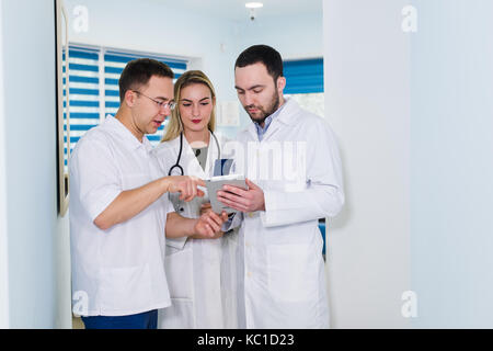 Portrait of medical team standing in hospital hall Stock Photo