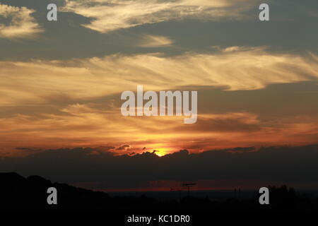 Golden sunset over a town at dusk Stock Photo