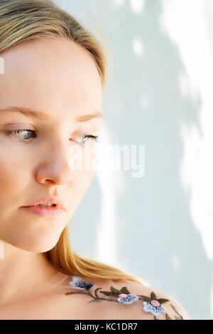 Profile of young woman gazing away thoughtfully Stock Photo