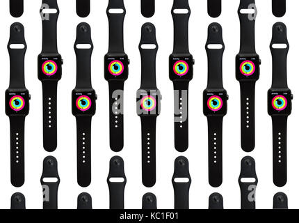 Rows of the Apple Watch Series 2 (38mm with Space Gray Aluminum with Black Sport Band) showing the colorful rings of the Activity fitness tracker app. Stock Photo