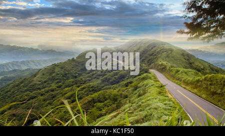 road under a sunrise time with nice sky with soft clouds Stock Photo