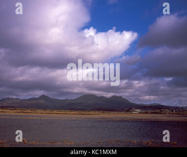 The Moelwyn Mountains and Cnicht looking across the flooded estuary of the Afon Glaslyn from the Cob at Porthmadog Gwynedd Snowdonia Wales Stock Photo