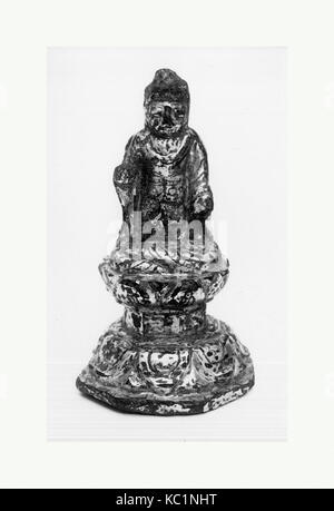 Statuette of Buddha Sitting on Engraved Throne, 10th century Stock Photo