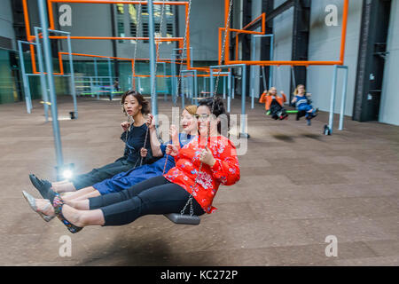 London, UK. 02nd Oct, 2017. Visitors enjoy the swings -0 The 2017 Hyundai Commission created by SUPERFLEX, a Danish collective, in the Turbine Hall at the Tate Modern. SUPERFLEX, known for their interests in unifying urban spaces and commenting on society with authenticity through art. London 02 Oct 2017. Credit: Guy Bell/Alamy Live News Stock Photo
