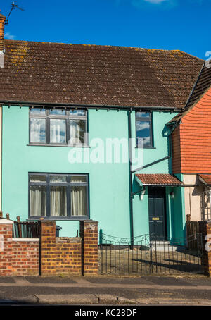 A sunlit, traditional-build, mid terrace house, painted green, located on an ex-council estate in South Ealing, London W5, England, UK. Stock Photo