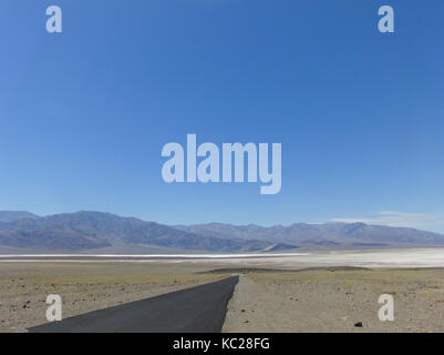 Open landscape with the road and mountains on background. Fantastic view on the valley desert. Stock Photo