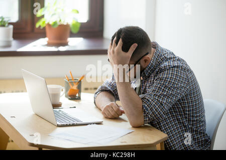 Young skilled joiner in workwear using drill, carpentry woodwork Stock Photo