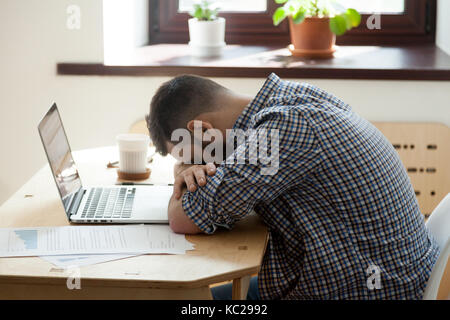 Carpenter using power hand saw cutting wooden planks in workshop Stock Photo