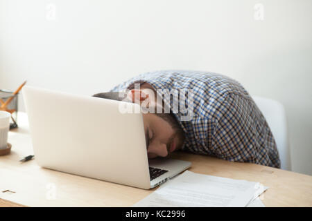 Carpentry workshop. Man using electric hand saw on wooden planks Stock Photo