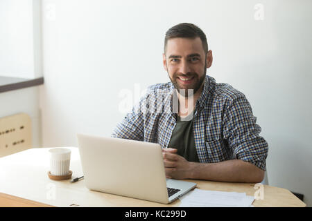 Man in protective glasses using angle grinder for cutting metal Stock Photo