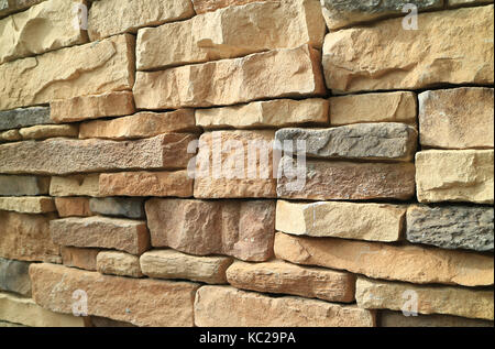 Light brown and grey color shade of rough stone wall in perspective view Stock Photo