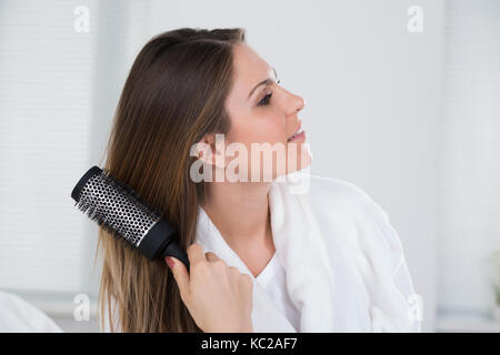 Close-up Of A Woman Combing Her Hair Stock Photo