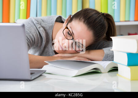 Tired Young College Student Sleeping In Library Stock Photo