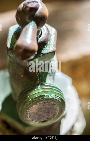 An old faucet clogged with cobwebs Stock Photo