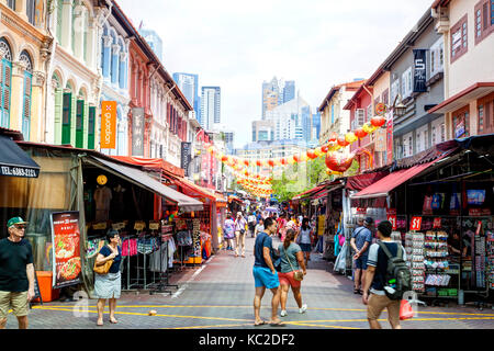 SINGAPORE - SEPTEMBER 11, 2017: Shoppers visiting Chinatown for bargain souvenirs and authentic local food. The old Victorian-style shophouses are a t Stock Photo