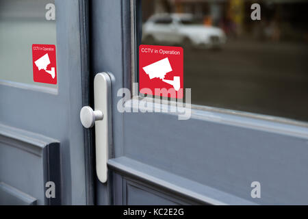 Close-up Of Warning Sticker Of Security Alarm Cctv Camera On Door Stock Photo