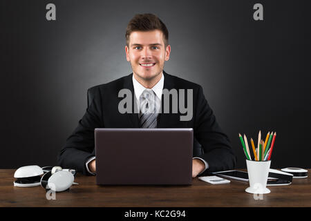 Young Happy Businessman Working With Laptop At Desk Stock Photo