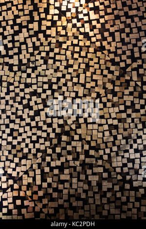 the wall made from gold foil sticked by random look like mosaic Stock Photo