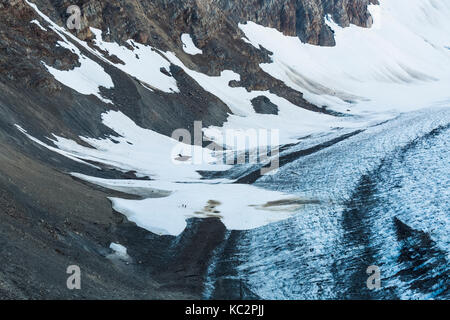 Blue Glacier, with two climbers on a snow field originating from an avalanche, at the end of the Hoh River Trail in Olympic National Park, Washington  Stock Photo
