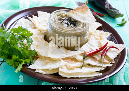 Light dietary pate from eggplant. Baba ganush is an Asian dish. Serve with thin lavash on a ceramic bowl. Stock Photo