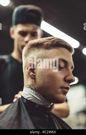 Anonymous barber preparing client Stock Photo