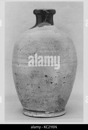 Wine Bottle, 19th century, Japan, Clay covered with white slip and a crackled transparent glaze; darker glaze around the neck Stock Photo