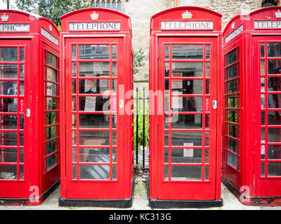 A close up of four traditional red telephone boxes in the Market Square in Cambridge UK Stock Photo