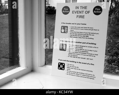 In the event of fire notice situated in entrance lobby to residential apartment block Stock Photo