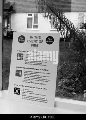 In the event of fire notice situated in entrance lobby to residential apartment block Stock Photo