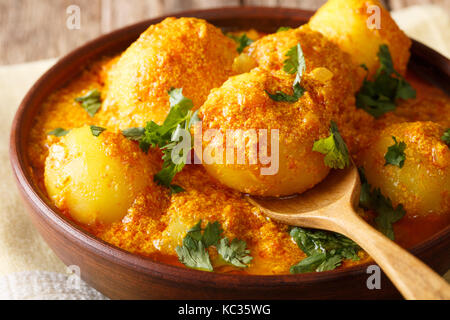Kashmiri dum aloo: spicy potato closeup on the pan on the table. Horizontal Stock Photo
