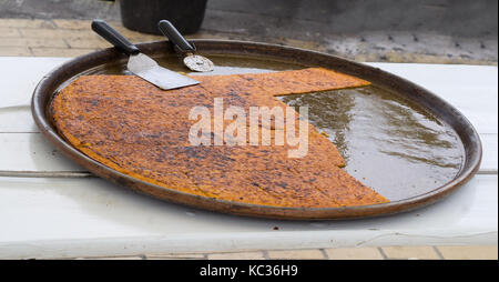 big Plate of Farinata or Cecina or Torta di ceci thin unleavened pancake or crepe of chickpea flour originating in Genoa cooked in a wood oven Stock Photo