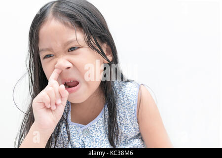 Little cute girl pick her nose on white background, Health care and hygiene concept Stock Photo
