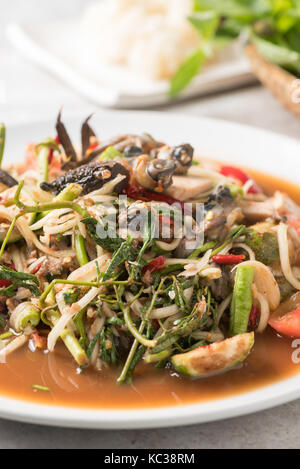 Thai Spicy papaya salad with pork sausage, Salted crab, scald snail and Sticky rice: Popular Thai Cuisine food Stock Photo