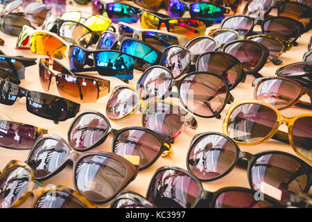 Many different colorful sunglasses in a diagonal row Stock Photo
