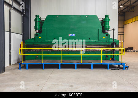 Hydraulic Sheet Metal Press Brake in big industrial hall Stock Photo