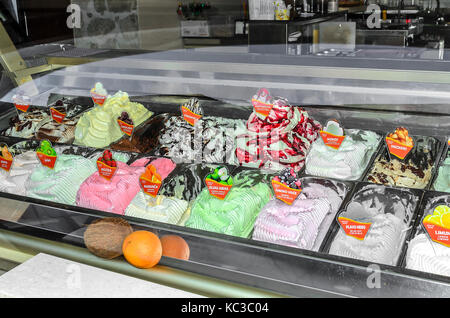 Ice cream in the refrigerator on the storefront. Stock Photo