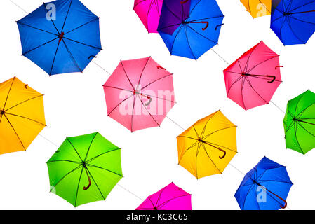 Many colorful umbrellas hanging, isolated on white background, view from below Stock Photo