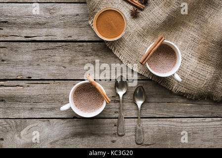 cups of cacao and spices on table Stock Photo