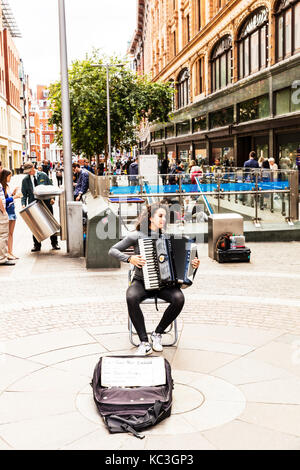 Accordion player, playing accordion, Accordion, busker playing Accordion, Accordion busker,  girl playing Accordion, piano Accordion, playing piano Stock Photo